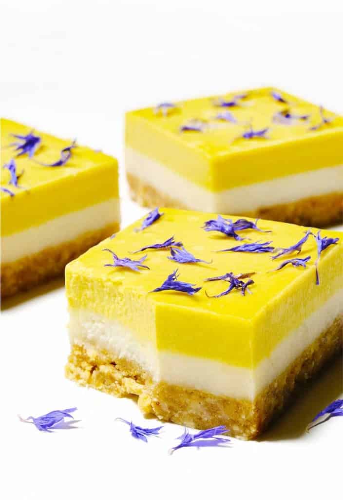 Lemon vegan raw cakes with purple edible flowers