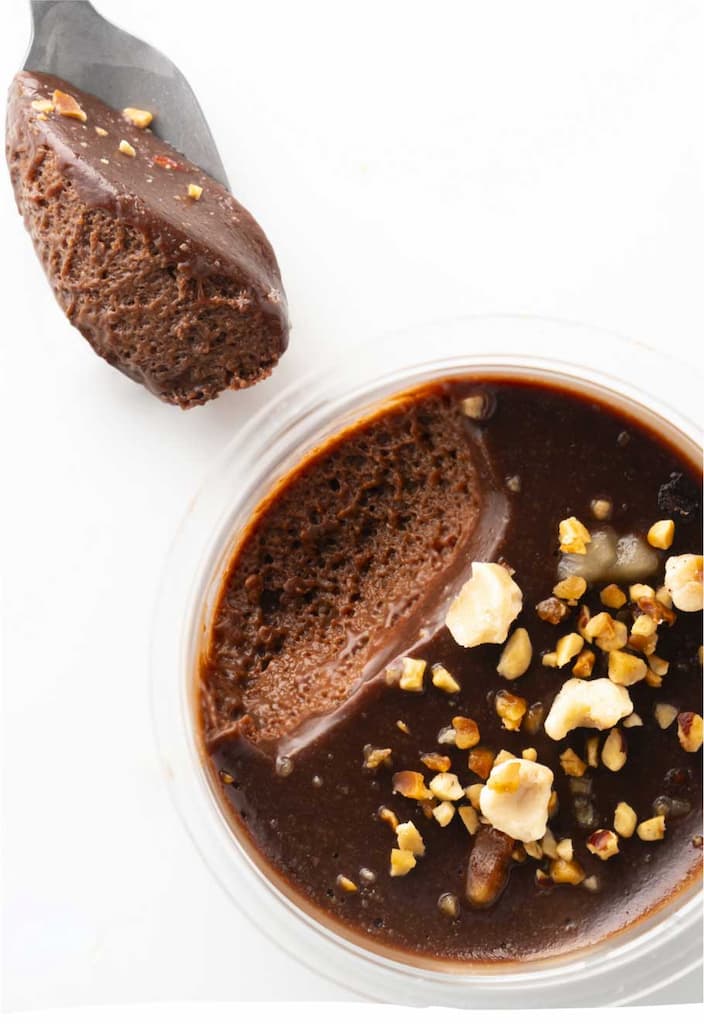 Chocolate mousse with hazelnuts and spoon.